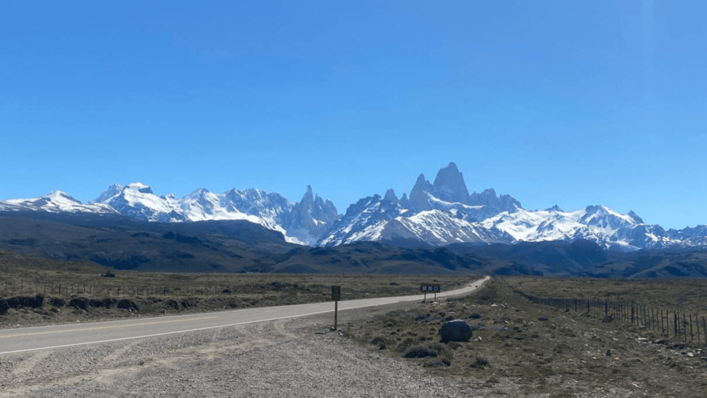 Monte Fitz Roy em El Chaltén, com picos cobertos de neve e céu azul ao fundo, mostrando a imponência das montanhas andinas que podem ser visitadas na mesma viagem a El Calafate.